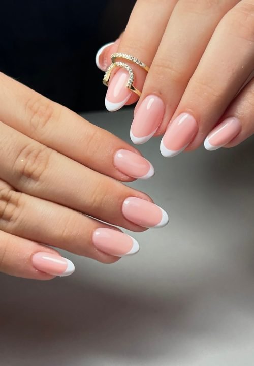 Young woman with simple manicure. Art nail with light and drak colors