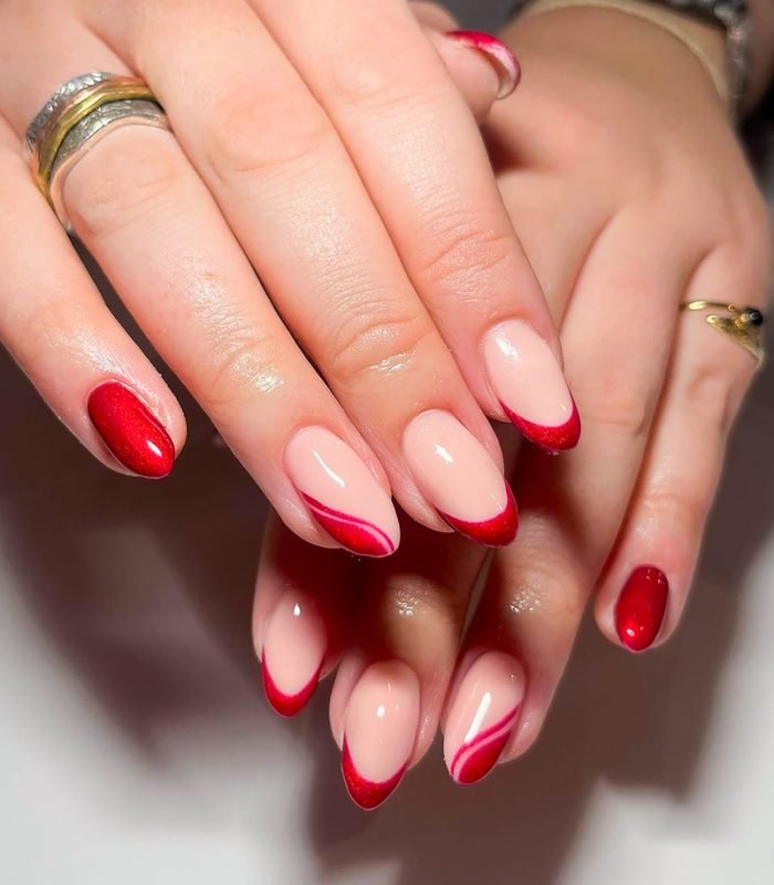 Woman's hand with trendy red wavy-pattern gel nails. Nail design. Mancure. Red nail. Luxury nail. Trendy. Nail salon
